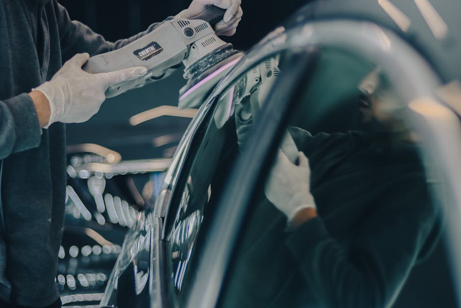 Auto detailer carefully polishing a car